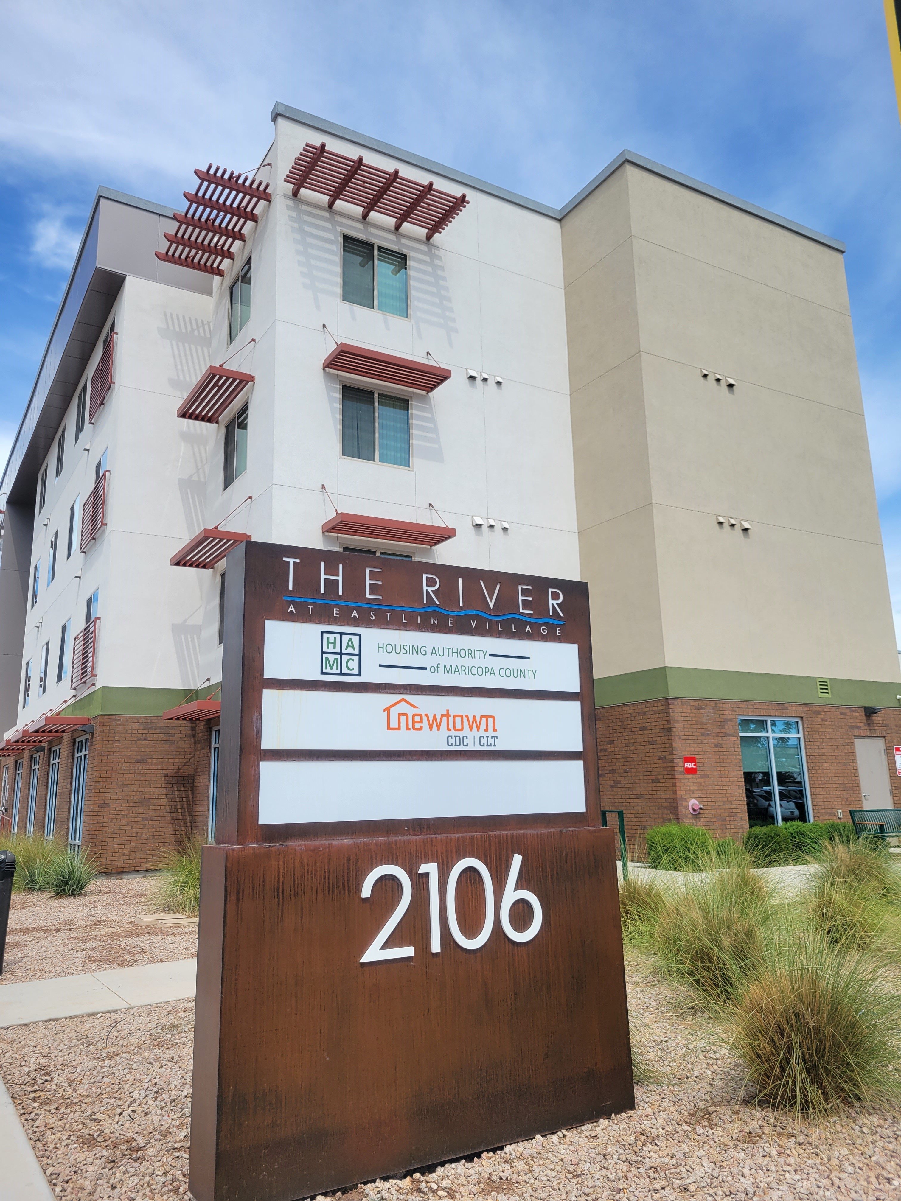 the river apartments sign in front of the building